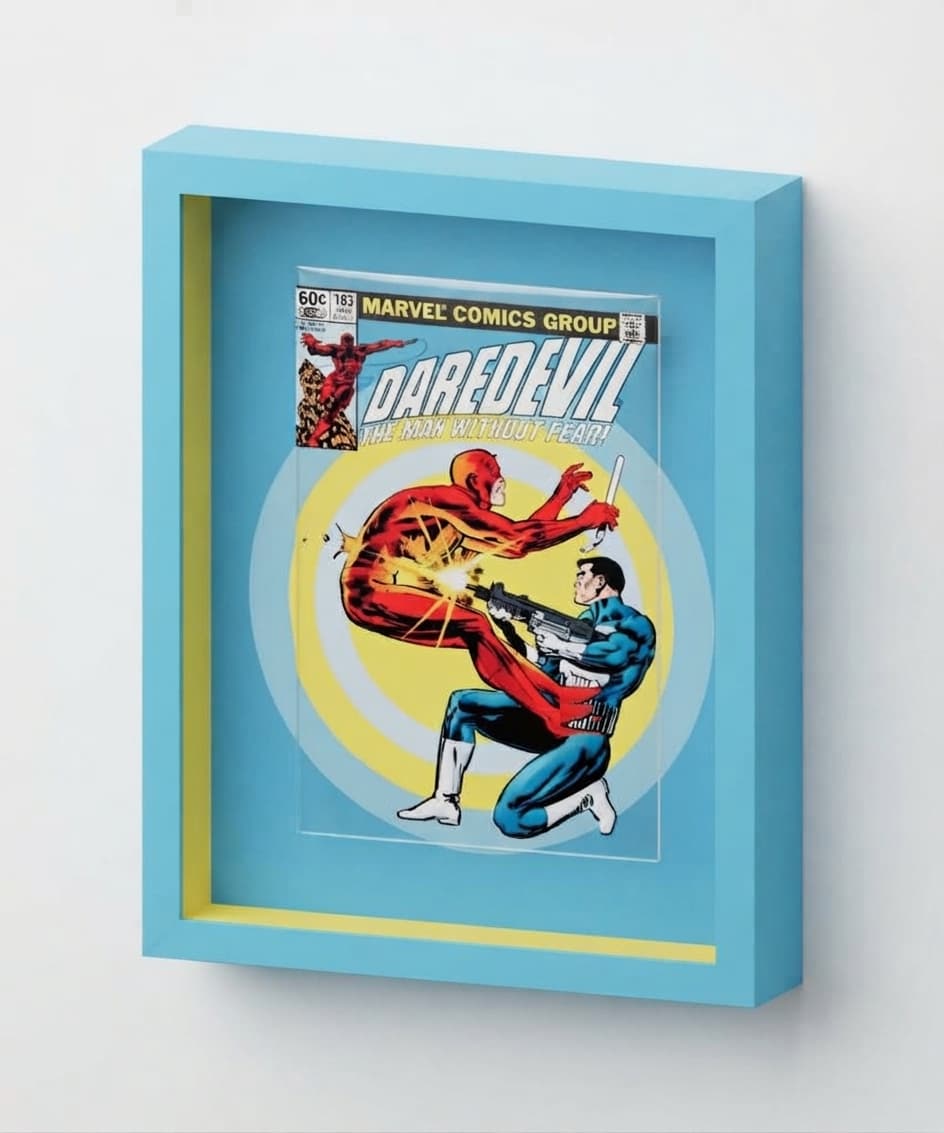 Daredevil issue 183 in a blue frame with a yellow spacer and the cover’s rings extended across the background